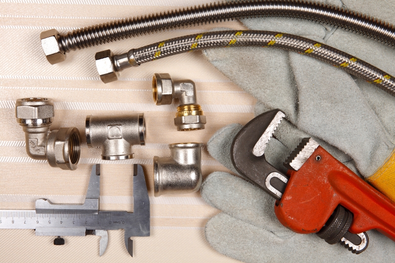 Plumber working on pipes in a Thornton Heath home